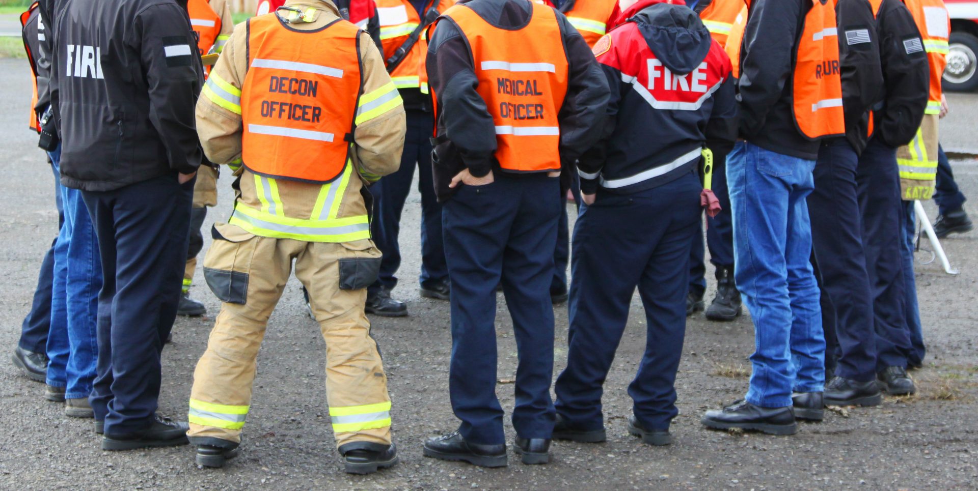 In any urban area the fire departments and emergency response teams will conduct disaster preparedness drills. This group of team members gathers around to discuss options.