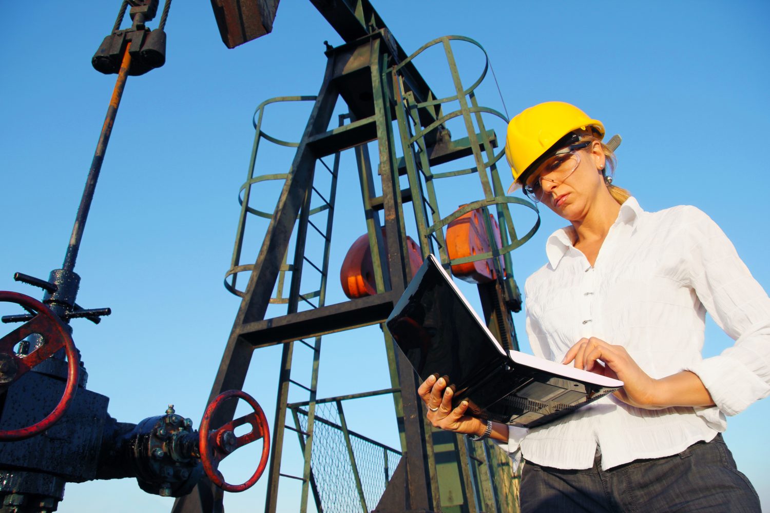 Businesswoman with a notebook in an oilfield