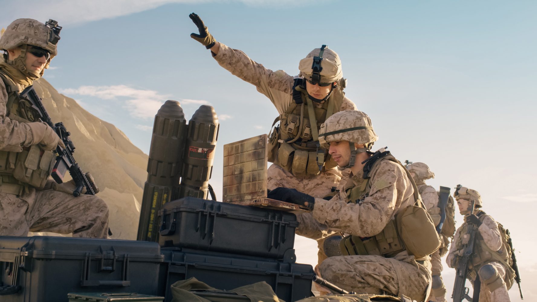 Soldiers are Using Laptop Computer for Surveillance During Military Operation in the Desert. Soldiers are Using Laptop Computer for Surveillance During Military Operation in the Desert.